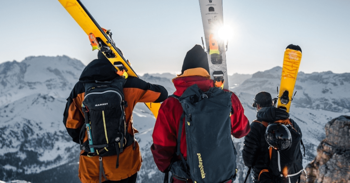 Group of backcountry skiers at a mountaintop.