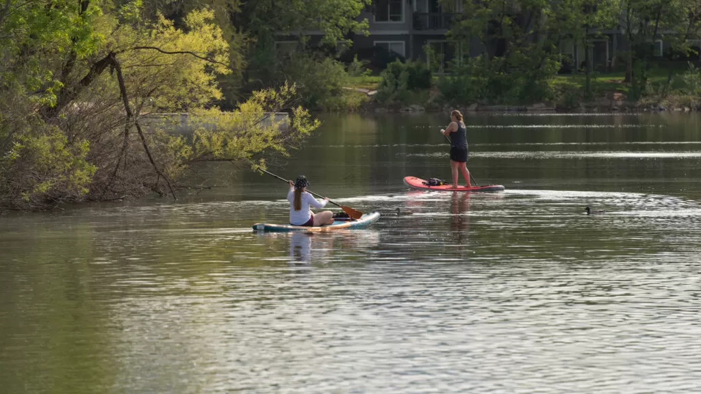 Ladies paddle boarding at Boise whitewater park photo Hunter Smith